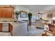 Open kitchen with breakfast bar and view into living room at 204 Mystic Falls Dr, Apollo Beach, FL 33572