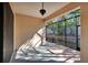Bright screened porch with ceiling fan and view of trees at 204 Mystic Falls Dr, Apollo Beach, FL 33572
