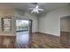 Bright living room with wood floors, sliding glass doors, and ceiling fan at 20538 Homossasa Ct, Land O Lakes, FL 34637