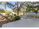 White wooden deck overlooks a spacious backyard with lush landscaping at 2312 14Th W Ave, Bradenton, FL 34205