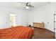 Bedroom with wood-look floors, ceiling fan, and dresser at 30009 Morningmist Dr, Wesley Chapel, FL 33543