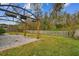 Covered patio with pergola and grassy backyard at 30009 Morningmist Dr, Wesley Chapel, FL 33543