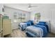 Bright bedroom with two twin beds, light wood floors, and a window with blinds at 3636 Trophy Blvd # 3636, New Port Richey, FL 34655