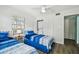 Bedroom with two twin beds, in-room laundry, and light wood floors at 3636 Trophy Blvd # 3636, New Port Richey, FL 34655