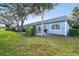 Light blue building with patio, grill, and lush lawn at 3636 Trophy Blvd # 3636, New Port Richey, FL 34655