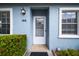 Front door and entryway of a light blue house with landscaping at 3636 Trophy Blvd # 3636, New Port Richey, FL 34655