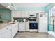 White kitchen with stainless steel appliances and mosaic backsplash at 3636 Trophy Blvd # 3636, New Port Richey, FL 34655