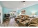Living room with brown sectional and sliding doors to patio at 3636 Trophy Blvd # 3636, New Port Richey, FL 34655