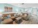 Living room with brown sectional sofa and view into kitchen at 3636 Trophy Blvd # 3636, New Port Richey, FL 34655