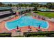 Kidney shaped pool with patio and lounge chairs at 3636 Trophy Blvd # 3636, New Port Richey, FL 34655