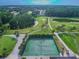 Community tennis courts next to a tranquil pond and golf course at 3636 Trophy Blvd # 3636, New Port Richey, FL 34655