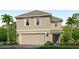 Two-story home with a two-car garage, landscaped yard, and palm trees at 5009 Rocky Coast Pl, Palmetto, FL 34221