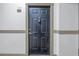 Black front door with a simple design, located in a condo hallway at 501 Knights Run Ave # 2308, Tampa, FL 33602