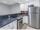 Modern kitchen with stainless steel appliances and white cabinets at 501 Knights Run Ave # 2308, Tampa, FL 33602