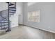 Bright living room with spiral staircase and laminate wood floors at 501 Knights Run Ave # 2308, Tampa, FL 33602