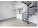 Open living area featuring a spiral staircase and high ceilings at 501 Knights Run Ave # 2308, Tampa, FL 33602
