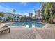 Community pool with lounge chairs and brick patio at 501 Knights Run Ave # 2308, Tampa, FL 33602