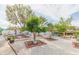 Backyard garden with fruit trees, white fence, and a dock in the background at 6512 Manila Palm Way, Apollo Beach, FL 33572