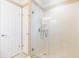 Modern bathroom with glass shower and white tiled walls at 6512 Manila Palm Way, Apollo Beach, FL 33572