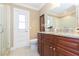 Elegant bathroom boasts granite countertop, wooden cabinetry, and a glass shower at 6512 Manila Palm Way, Apollo Beach, FL 33572