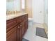 Stylish bathroom featuring a granite countertop, wooden cabinetry, and a glass shower enclosure at 6512 Manila Palm Way, Apollo Beach, FL 33572