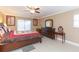 Comfortable bedroom featuring wooden furniture, ceiling fan, and a cozy atmosphere at 6512 Manila Palm Way, Apollo Beach, FL 33572