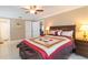 Spacious bedroom with wooden furniture, ceiling fan, and ample natural light at 6512 Manila Palm Way, Apollo Beach, FL 33572