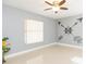 Bright bedroom with minimalist decor, a ceiling fan, and modern accents at 6512 Manila Palm Way, Apollo Beach, FL 33572