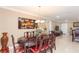 Dining area with ornate table, red chairs, and decorative art at 6512 Manila Palm Way, Apollo Beach, FL 33572