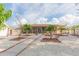 Rear exterior elevation featuring a screened porch, landscaping, and garden beds at 6512 Manila Palm Way, Apollo Beach, FL 33572