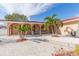 Paved walkway leads to the arched front entrance of this single-story home at 6512 Manila Palm Way, Apollo Beach, FL 33572