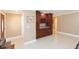 Home office area with built-in cabinets, wine rack, and tile flooring at 6512 Manila Palm Way, Apollo Beach, FL 33572