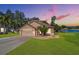 Two-story house with a two-car garage and landscaped lawn at dusk at 727 Grand Canyon Dr, Valrico, FL 33594