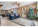 Living room with a blue sofa, Christmas tree, and view of kitchen at 727 Grand Canyon Dr, Valrico, FL 33594