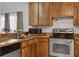 Kitchen with wood cabinets, stainless steel appliances, and tiled floors at 7901 Sugarcane Ct, Temple Terrace, FL 33637