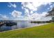 Scenic lakefront view with boat dock and lush greenery at 90 S Highland Ave # 416, Tarpon Springs, FL 34689