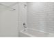 Clean bathroom with white subway tile and bathtub at 10336 Cross River Trl, Parrish, FL 34219