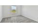 Simple bedroom with grey carpet and a window at 10336 Cross River Trl, Parrish, FL 34219