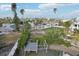 Aerial view of a waterfront home with a private dock and lush landscaping at 15825 Redington Dr, Redington Beach, FL 33708