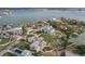 Aerial view of a waterfront property with a large lot and neighboring houses at 15825 Redington Dr, Redington Beach, FL 33708