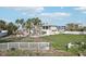 Large backyard with a white fence and palm trees at 15825 Redington Dr, Redington Beach, FL 33708