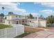 House exterior showcasing a two-story home with a white fence and driveway at 15825 Redington Dr, Redington Beach, FL 33708