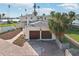 Two-car garage with brown doors, located on a waterfront property at 15825 Redington Dr, Redington Beach, FL 33708