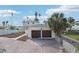 Two-car garage with brown doors, located on a waterfront property at 15825 Redington Dr, Redington Beach, FL 33708