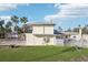Side view of two-story house with a large yard at 15825 Redington Dr, Redington Beach, FL 33708
