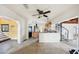 Open kitchen with island, wood cabinets, and view of the living area at 15825 Redington Dr, Redington Beach, FL 33708