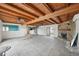 Spacious living room featuring wood beams, a stone fireplace, and tile floors at 15825 Redington Dr, Redington Beach, FL 33708