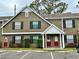 Two-story townhome featuring a red door and black shutters at 16543 Lake Brigadoon Cir, Tampa, FL 33618