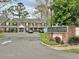 Lake Heather Townhomes street view with parking and community sign at 16543 Lake Brigadoon Cir, Tampa, FL 33618
