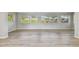 Bright living room with light wood flooring and large windows at 1701 62Nd S Ter, St Petersburg, FL 33712